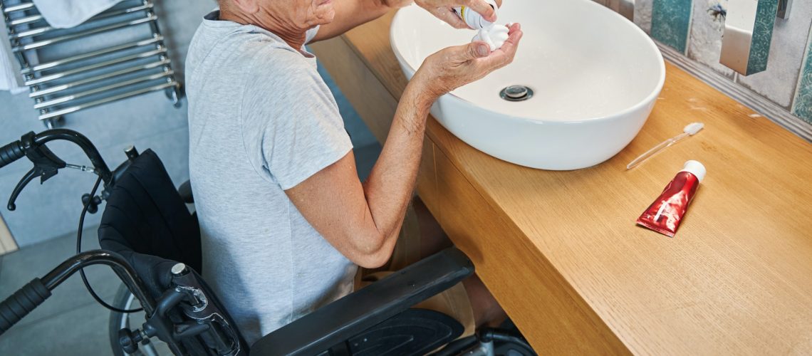 Male with disability pouring shaving cream on his palm